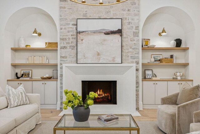 9314 Double Run Ct, College Grove, TN 37046 - living area featuring built in features, light wood-style floors, and a fireplace with flush hearth