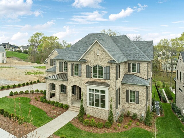 9314 Double Run Ct, College Grove, TN 37046 - french country home featuring brick siding, cooling unit, a porch, a standing seam roof, and roof with shingles