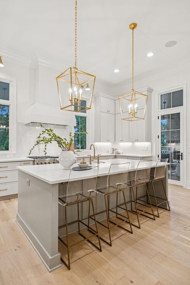 9314 Double Run Ct, College Grove, TN 37046 - kitchen with a chandelier, ornamental molding, light wood-style flooring, decorative backsplash, and white cabinets