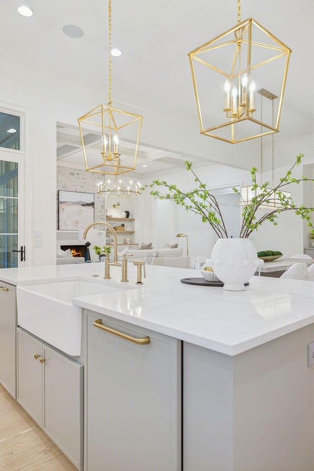 9314 Double Run Ct, College Grove, TN 37046 - kitchen featuring a chandelier, open floor plan, a sink, pendant lighting, and ornamental molding