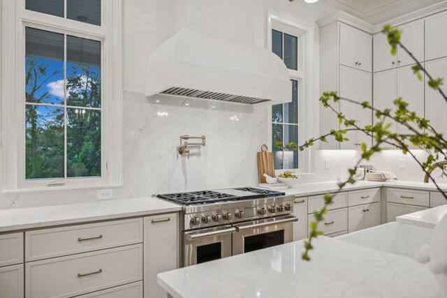 9314 Double Run Ct, College Grove, TN 37046 - kitchen with range with two ovens, custom range hood, tasteful backsplash, white cabinetry, and healthy amount of natural light