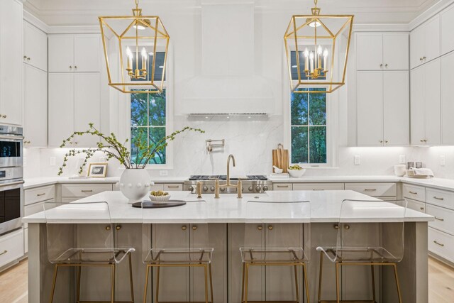 9314 Double Run Ct, College Grove, TN 37046 - kitchen featuring a chandelier, white cabinetry, decorative backsplash, and a breakfast bar area