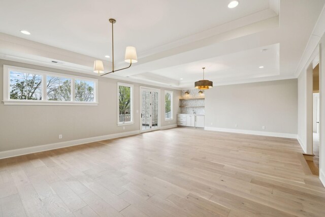 9314 Double Run Ct, College Grove, TN 37046 - unfurnished living room featuring a raised ceiling, baseboards, light wood-style flooring, recessed lighting, and crown molding