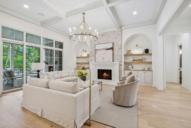 9314 Double Run Ct, College Grove, TN 37046 - living area with a large fireplace, light wood finished floors, beamed ceiling, a chandelier, and built in shelves