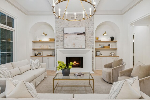 9314 Double Run Ct, College Grove, TN 37046 - living room with built in shelves, a chandelier, ornamental molding, and a fireplace with flush hearth