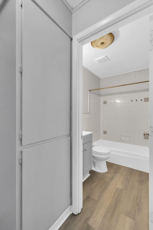123 S Sam Davis Ave, Pulaski, TN 38478 - bathroom featuring toilet, wood finished floors, vanity, and tub / shower combination