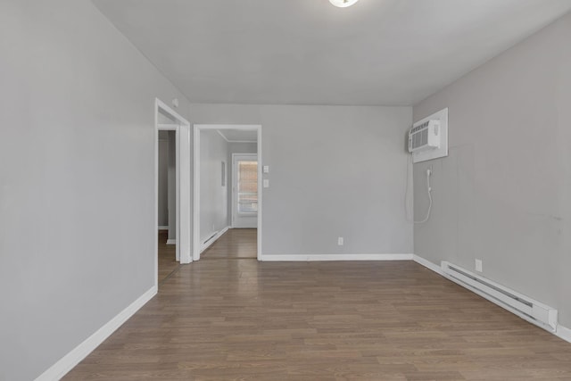 123 S Sam Davis Ave, Pulaski, TN 38478 - empty room with a baseboard heating unit, wood finished floors, a wall mounted air conditioner, and baseboards