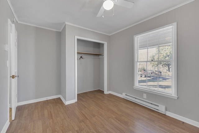 123 S Sam Davis Ave, Pulaski, TN 38478 - unfurnished bedroom featuring a baseboard radiator, wood finished floors, crown molding, a closet, and baseboards