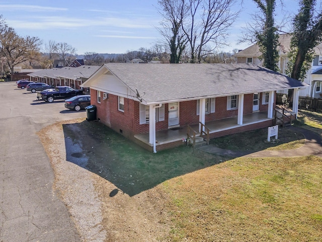 123 S Sam Davis Ave, Pulaski, TN 38478 - view of front facade featuring brick siding, covered porch, roof with shingles, a front yard, and a residential view