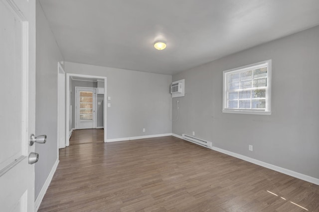 123 S Sam Davis Ave, Pulaski, TN 38478 - unfurnished room with baseboard heating, healthy amount of natural light, and wood finished floors