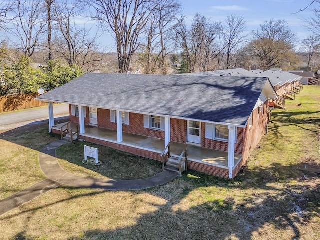 123 S Sam Davis Ave, Pulaski, TN 38478 - view of front of home with a porch, a shingled roof, and brick siding