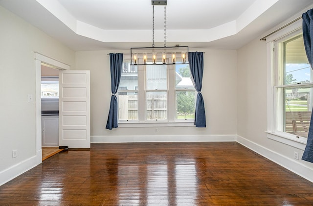 213 Maple St, Bell Buckle, TN 37020 - unfurnished dining area with a raised ceiling, hardwood / wood-style flooring, and baseboards