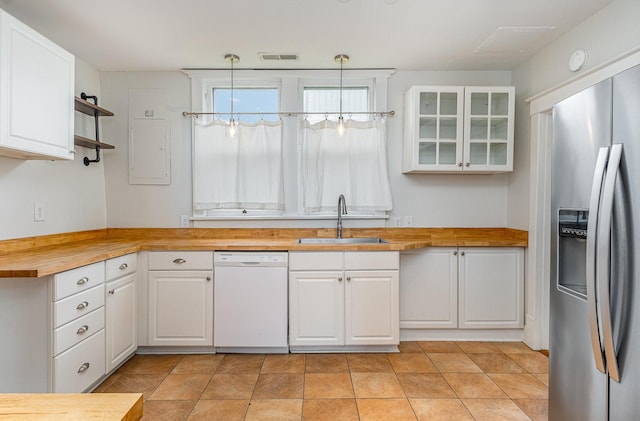 213 Maple St, Bell Buckle, TN 37020 - kitchen featuring white dishwasher, stainless steel fridge, wood counters, a sink, and white cabinetry