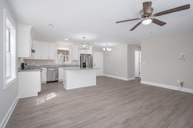 201 Welker Rd, Cedar Hill, TN 37032 - kitchen featuring stainless steel appliances, a chandelier, open floor plan, a kitchen island, and a ceiling fan