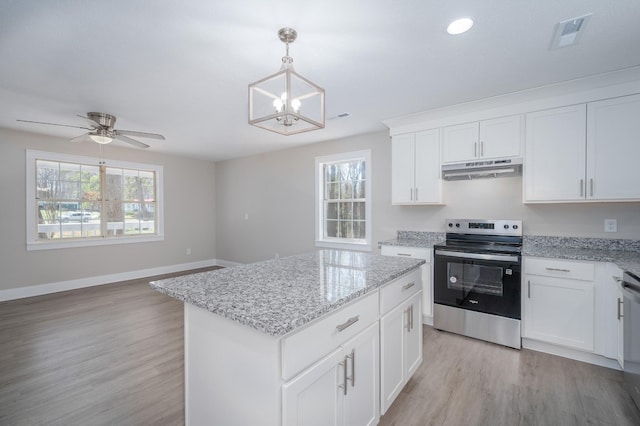 201 Welker Rd, Cedar Hill, TN 37032 - kitchen with stainless steel range with electric cooktop, under cabinet range hood, a chandelier, light wood-style flooring, and a kitchen island