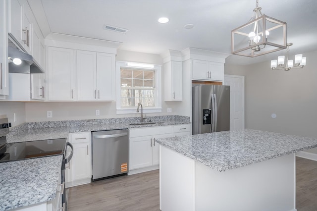 201 Welker Rd, Cedar Hill, TN 37032 - kitchen with appliances with stainless steel finishes, a sink, a chandelier, light wood finished floors, and white cabinets