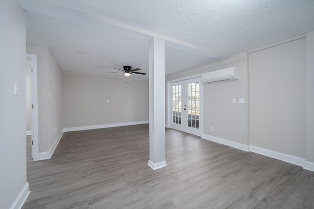 201 Welker Rd, Cedar Hill, TN 37032 - unfurnished living room with an AC wall unit, wood finished floors, a ceiling fan, baseboards, and french doors