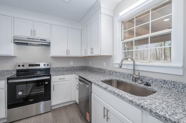 201 Welker Rd, Cedar Hill, TN 37032 - kitchen featuring under cabinet range hood, stainless steel appliances, a sink, white cabinets, and light wood-type flooring