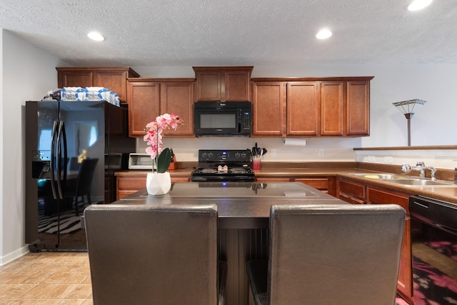 5104 Preserve Blvd, Antioch, TN 37013 - kitchen with black appliances, brown cabinets, a kitchen island, recessed lighting, and dark countertops