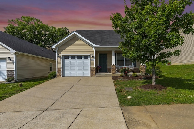 5104 Preserve Blvd, Antioch, TN 37013 - view of front of house featuring an attached garage, concrete driveway, covered porch, a front lawn, and roof with shingles