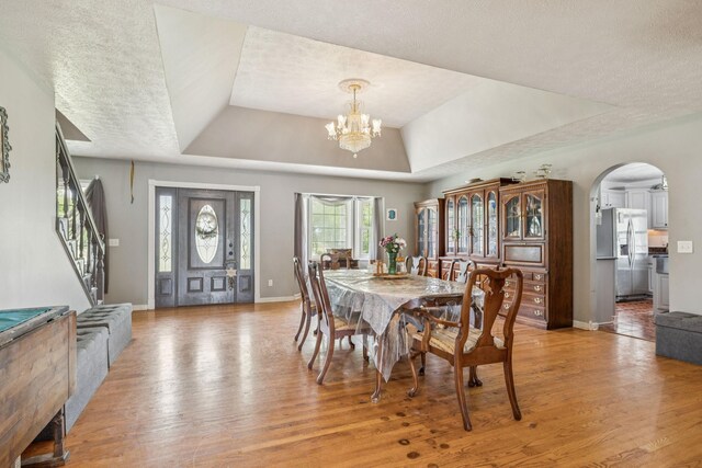 834 Union Camp Rd, Lafayette, TN 37083 - dining area with a raised ceiling, light wood-style flooring, stairway, baseboards, and a textured ceiling