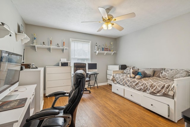 834 Union Camp Rd, Lafayette, TN 37083 - bedroom with wood finished floors, a desk, a textured ceiling, and a ceiling fan