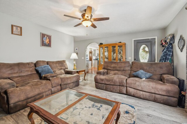834 Union Camp Rd, Lafayette, TN 37083 - living room featuring arched walkways, a ceiling fan, and wood finished floors