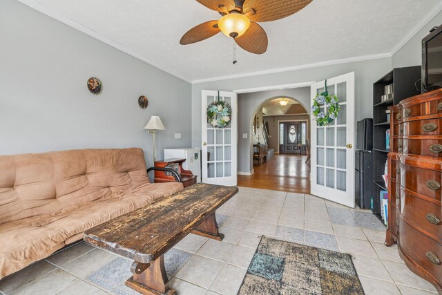834 Union Camp Rd, Lafayette, TN 37083 - tiled living room featuring french doors, arched walkways, a ceiling fan, and crown molding
