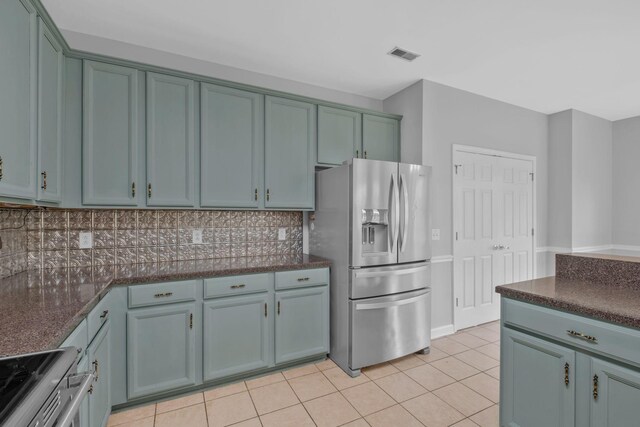 5000 Loch Lorne Ct, Mount Juliet, TN 37122 - kitchen with appliances with stainless steel finishes, tasteful backsplash, light tile patterned flooring, dark stone counters, and blue cabinets