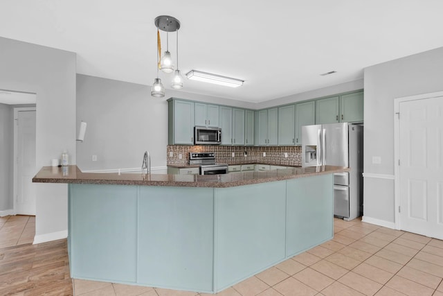 5000 Loch Lorne Ct, Mount Juliet, TN 37122 - kitchen featuring stainless steel appliances, decorative backsplash, light tile patterned floors, dark stone counters, and hanging light fixtures