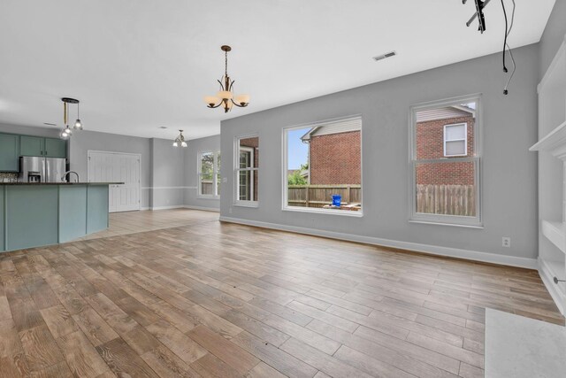 5000 Loch Lorne Ct, Mount Juliet, TN 37122 - unfurnished living room with a chandelier and light wood-style flooring