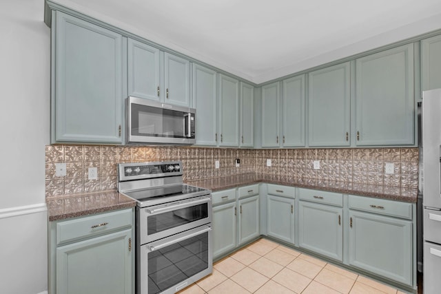 5000 Loch Lorne Ct, Mount Juliet, TN 37122 - kitchen with appliances with stainless steel finishes, tasteful backsplash, light tile patterned floors, and dark stone counters