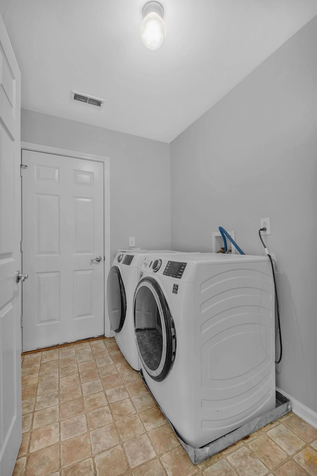 5000 Loch Lorne Ct, Mount Juliet, TN 37122 - laundry room with washing machine and clothes dryer and light stone finish floors