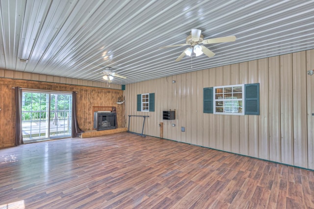417 Haskins Chapel Rd, Lewisburg, TN 37091 - unfurnished living room featuring ceiling fan, wood finished floors, a fireplace with raised hearth, and wooden walls