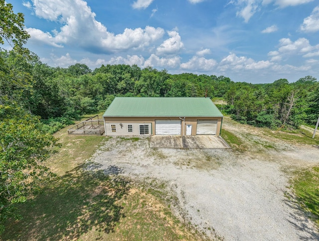 417 Haskins Chapel Rd, Lewisburg, TN 37091 - view of front facade with a view of trees, metal roof, a garage, and an outbuilding