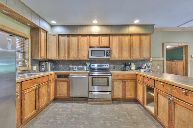417 Haskins Chapel Rd, Lewisburg, TN 37091 - kitchen with appliances with stainless steel finishes, a sink, brown cabinets, recessed lighting, and crown molding