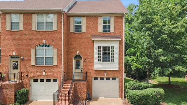 127 Carriage Ct, Brentwood, TN 37027 - townhome / multi-family property with an attached garage, concrete driveway, brick siding, and a shingled roof