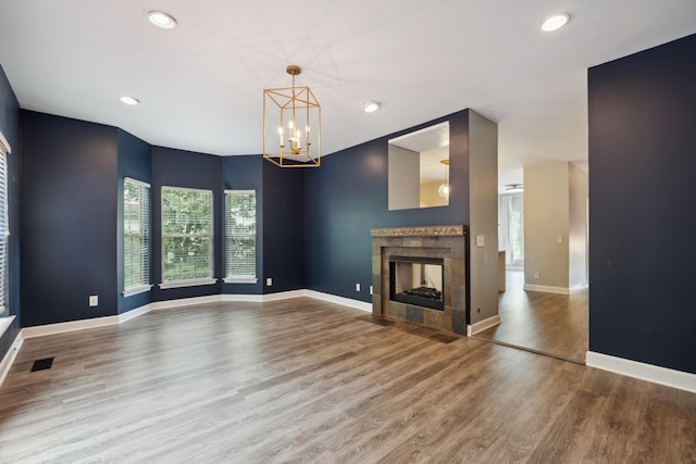 127 Carriage Ct, Brentwood, TN 37027 - unfurnished living room featuring wood finished floors, a chandelier, baseboards, a tile fireplace, and recessed lighting
