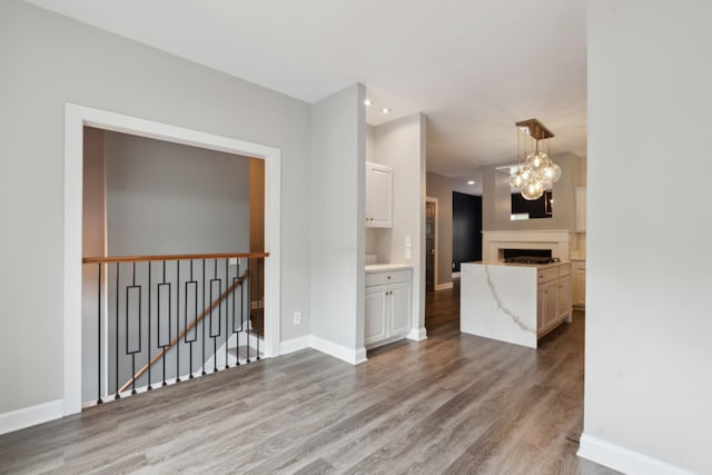127 Carriage Ct, Brentwood, TN 37027 - empty room featuring wood finished floors, a chandelier, baseboards, and recessed lighting