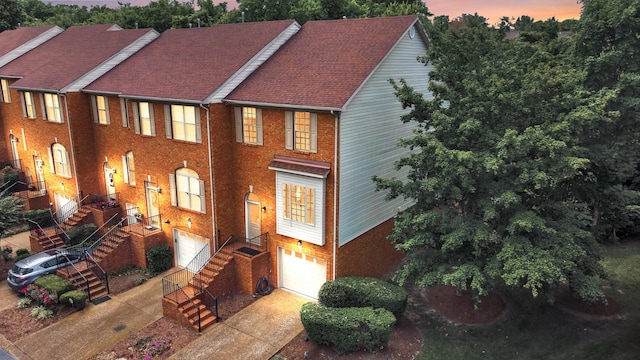 127 Carriage Ct, Brentwood, TN 37027 - view of front of house featuring a garage, brick siding, stairway, and driveway