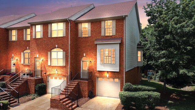 127 Carriage Ct, Brentwood, TN 37027 - multi unit property featuring a garage, driveway, brick siding, and stairs