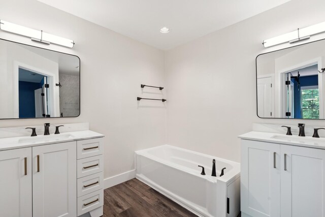 127 Carriage Ct, Brentwood, TN 37027 - full bath featuring two vanities, wood finished floors, a bath, baseboards, and recessed lighting