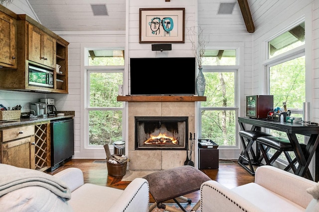 2541 Sparkmantown Rd, Doyle, TN 38559 - living room featuring dark wood-type flooring, lofted ceiling, a tile fireplace, wood ceiling, and wood walls