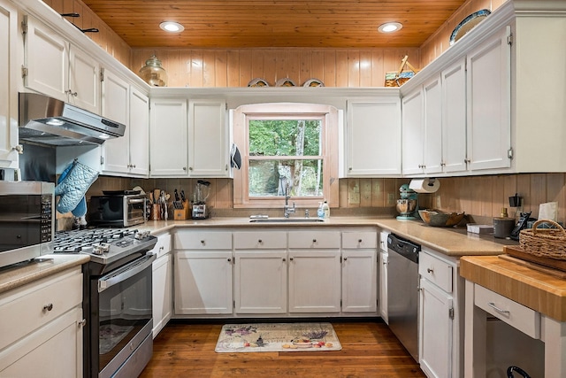 2541 Sparkmantown Rd, Doyle, TN 38559 - kitchen with wooden ceiling, appliances with stainless steel finishes, under cabinet range hood, white cabinetry, and dark wood-style floors