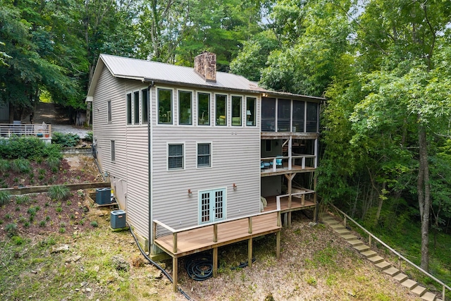 2541 Sparkmantown Rd, Doyle, TN 38559 - rear view of house featuring a chimney, a sunroom, a wooden deck, and french doors