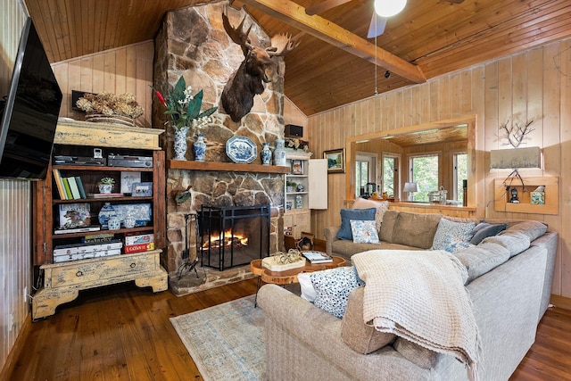 2541 Sparkmantown Rd, Doyle, TN 38559 - living area with a wooden ceiling with exposed beams, wooden walls, a stone fireplace, hardwood / wood-style flooring, and a ceiling fan