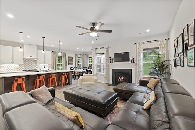 3067 Boxbury Ln, Spring Hill, TN 37174 - living area with healthy amount of natural light, ceiling fan, recessed lighting, a fireplace with flush hearth, and light wood finished floors