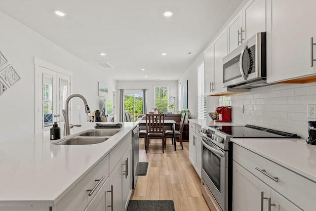 755 Mickelson Way, Lebanon, TN 37087 - kitchen featuring stainless steel appliances, recessed lighting, light countertops, light wood-style floors, and decorative backsplash