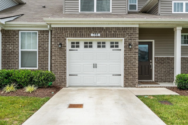 755 Mickelson Way, Lebanon, TN 37087 - property entrance with brick siding, a shingled roof, concrete driveway, and an attached garage