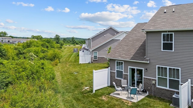755 Mickelson Way, Lebanon, TN 37087 - back of house with a patio area, a shingled roof, a lawn, and brick siding